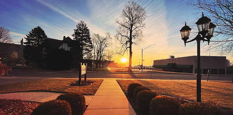 sunset over building sign